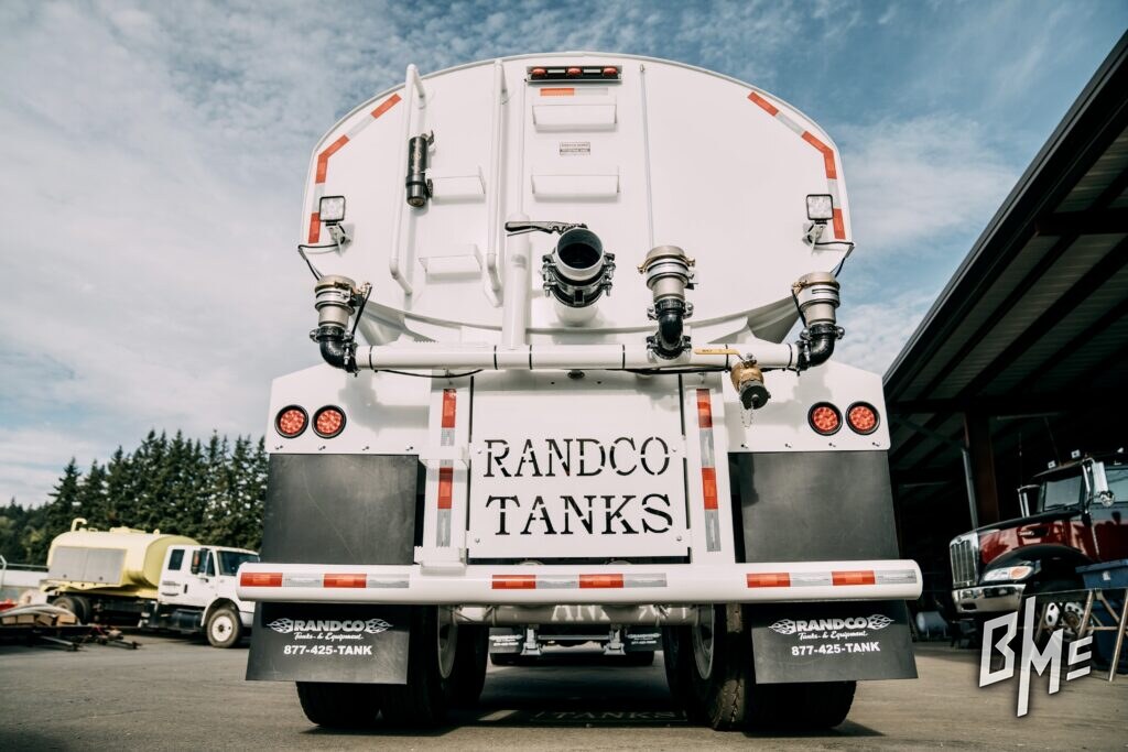 Rear view of a finished white water truck with spray fittings either side of the tailgate