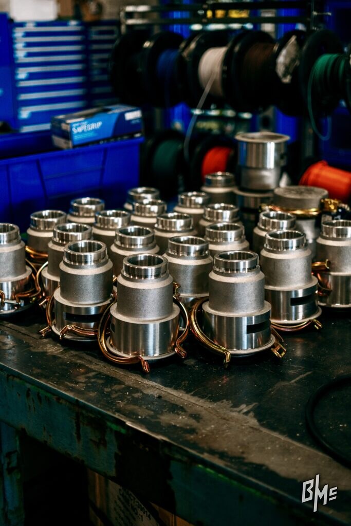 Assembled spray valves lined up along a shop bench