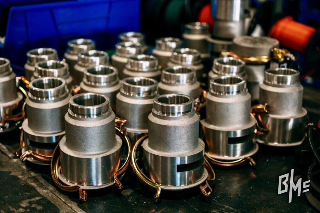 A batch of assembled B/Mc spray valves on a workbench