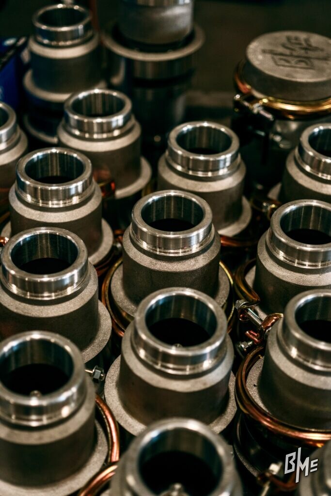 Close view of machined inlet bores on a batch of spray valve bodies