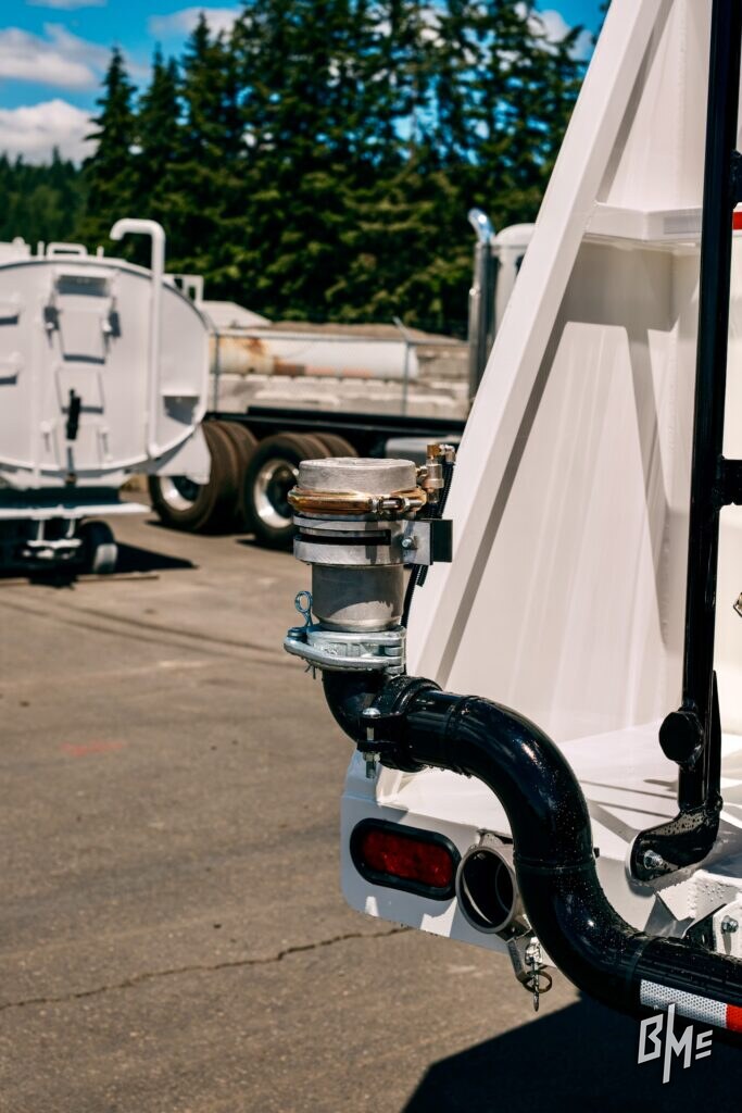 Water truck outdoors with a side-mounted spray valve