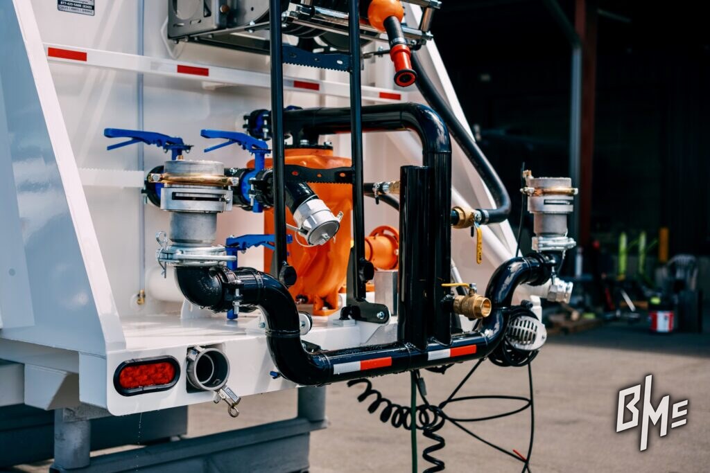 Spray valve and plumbing mounted at the rear of a white water truck