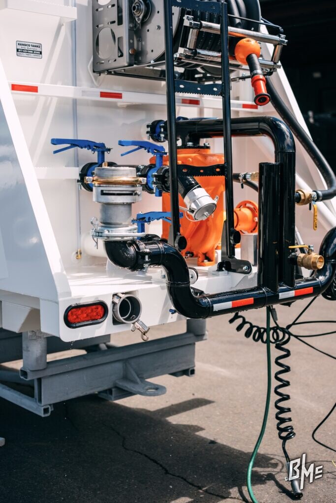 Spray valve and plumbing at the rear of a finished white water truck