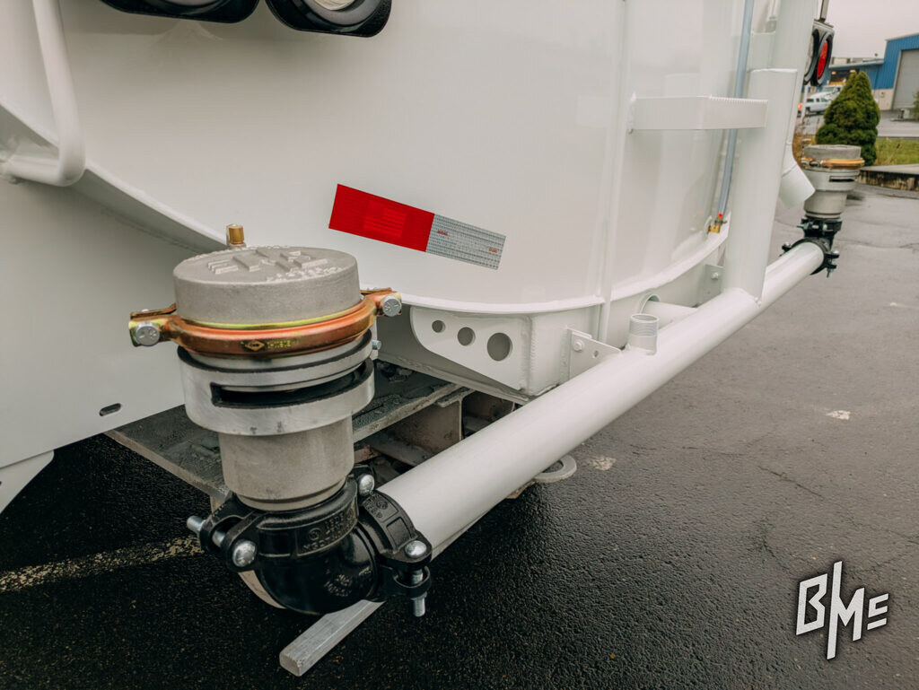 Spray valve and head mounted beneath a tanker